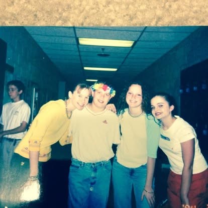 Flower crown and grins in the school hallway with the crew.