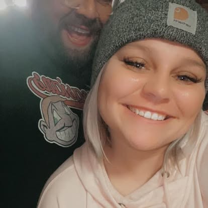 Big grins in a cozy night-out selfie together.