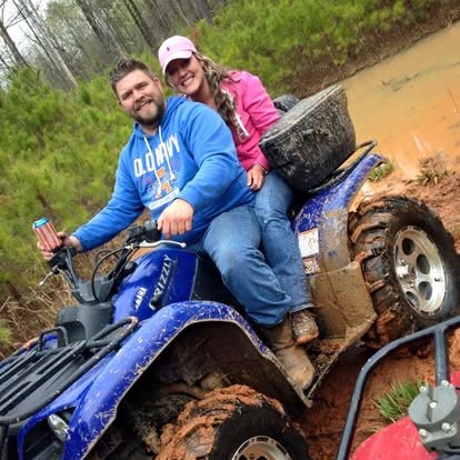 Muddy ATV ride together, drink up and smiling big.