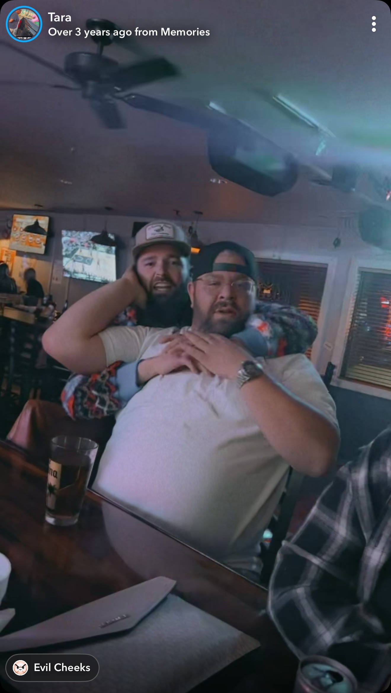 Bear hugs at the bar — a Snapchat memory with friends.